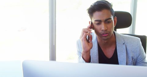 Confident Asian Businessman Engaged in Important Phone Call