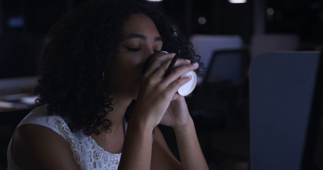 Woman Drinking Coffee at Desk during Late Night Work - Download Free Stock Images Pikwizard.com