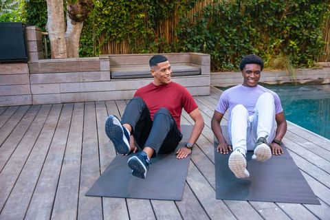 Friends Exercising Together by Pool on Sunny Day