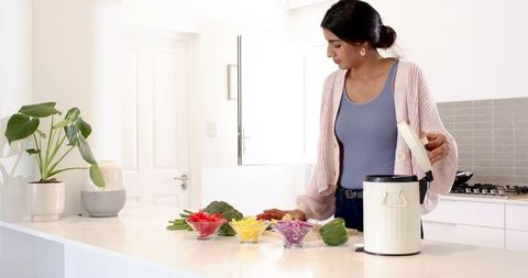 Woman Practicing Eco-Friendly Cooking in Modern Kitchen