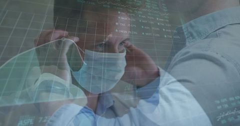 Medic Adjusting Surgical Mask Amid Digital Data Graphs