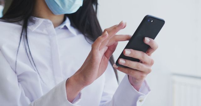 Woman in Face Mask Using Smartphone Indoors - Download Free Stock Images Pikwizard.com