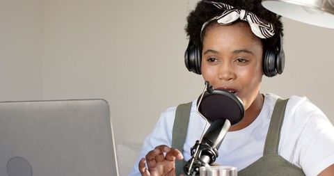Young Woman Podcasting at Home Wearing Headphones and Speaking into Microphone - Download Free Stock Images Pikwizard.com