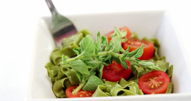 Close-Up of Fresh Spinach Pasta with Cherry Tomatoes and Basil - Download Free Stock Images Pikwizard.com