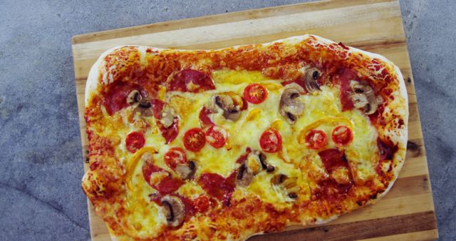 A rustic, homemade pizza with pepperoni, mushrooms, and tomatoes showcases a personal touch. - Download Free Stock Photos Pikwizard.com