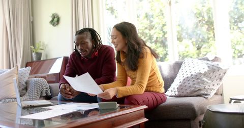 Diverse Couple Managing Finances Together in Bright Room - Download Free Stock Images Pikwizard.com
