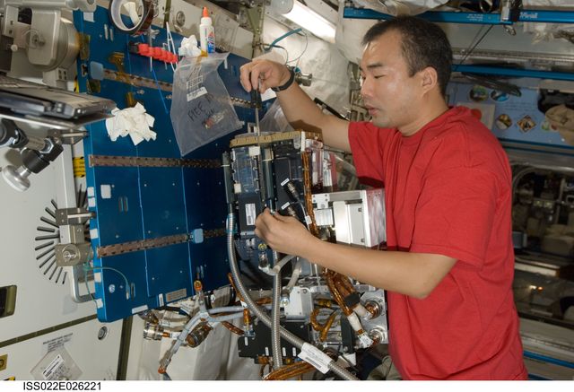 ISS022-E-026221 (15 Jan. 2010) --- Japan Aerospace Exploration Agency (JAXA) astronaut Soichi Noguchi, Expedition 22 flight engineer, services the Fluid Physics Experiment Facility/Marangoni Surface (FPEF MS) Core hardware in the Kibo laboratory of the International Space Station. The Marangoni convection experiment in the FPEF examines fluid tension flow in micro-G.