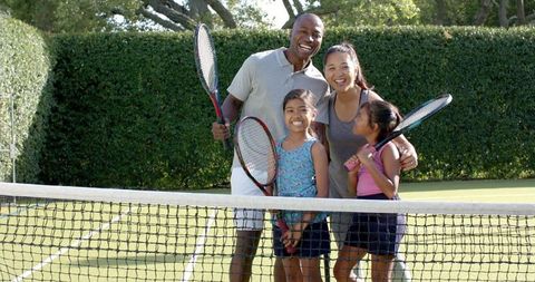 Family Bonding Through Tennis on Sunny Day