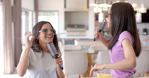 Teenage Friends Singing and Laughing with Hairbrushes - Download Free Stock Images Pikwizard.com