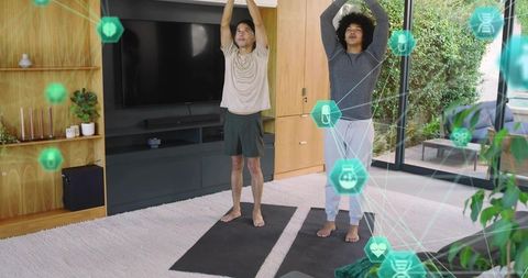 Two men practicing at-home yoga with digital wellness overlay for smart fitness