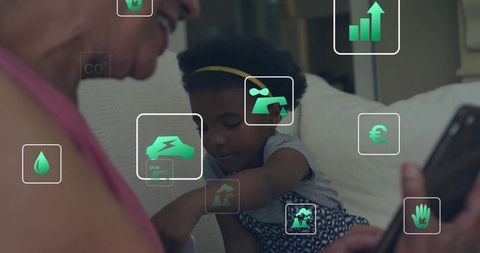 Grandmother and grandchild sharing tablet on sofa, child reaching, green eco icons overlay