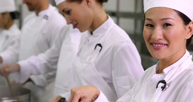 Smiling Chef in Professional Kitchen with Team Preparing Meals - Download Free Stock Images Pikwizard.com