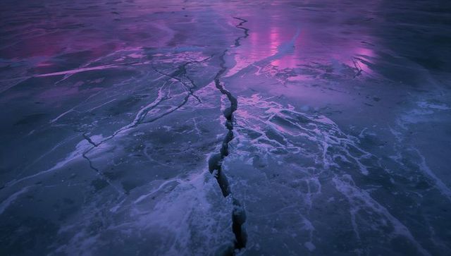 Jagged Ice Fissure on Frozen Lake at Twilight with Purple Magenta Reflections, Minimal