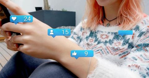 Young woman checking social media notifications outdoors