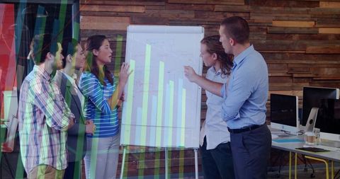 Female leader presenting data to team with projected bar charts and flip chart