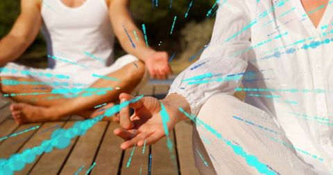Couple Practicing Outdoor Meditation on Wood Deck with Turquoise Energy Light Streaks