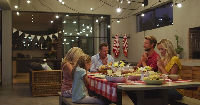 Family Praying Before Dinner in Festive Outdoor Setting - Download Free Stock Images Pikwizard.com