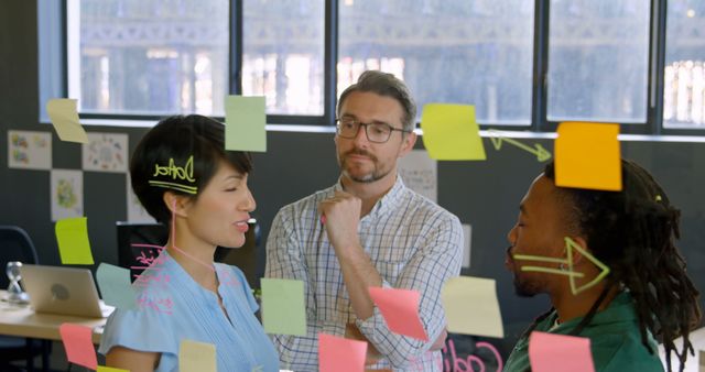 Team brainstorming ideas with colorful sticky notes on glass wall - Download Free Stock Images Pikwizard.com