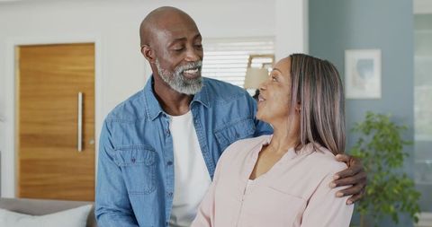 Warm african american senior couple sharing affectionate moment in modern living room
