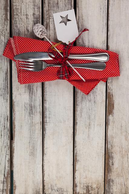 Festive Cutlery with Red Napkin on Rustic Wooden Table - Download Free Stock Photos Pikwizard.com