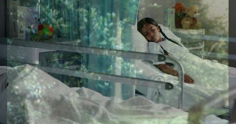 Young girl resting in pediatric bed with braided hair, soft daylight reflections