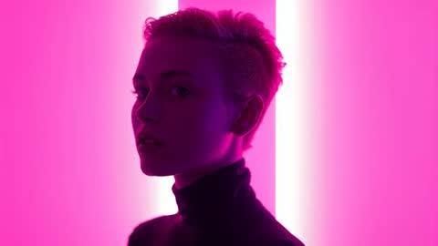 Stylish Model Posing Under Neon Magenta Lights in Studio