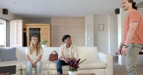 Friends Conversing at Home on Sofa in Bright Living Room