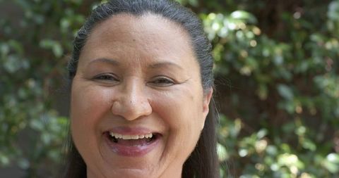 Mature african american woman laughing in garden capturing natural daylight and candid joy