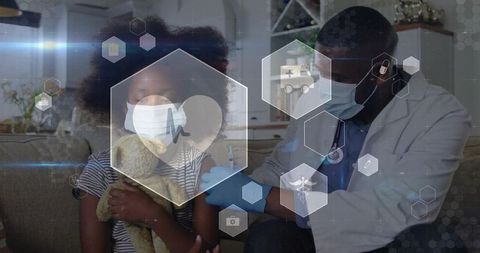 Masked doctor administering home vaccination to child holding teddy on couch telehealth care