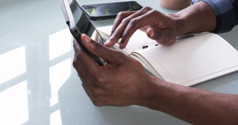 Tech Productivity with Tablet and Notebook on Glass Table