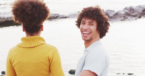 Smiling Diverse Couple Enjoying Oceanview at Sunset