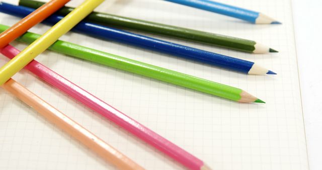 Close-up of Colorful Pencils on Notebook Surface - Download Free Stock Images Pikwizard.com