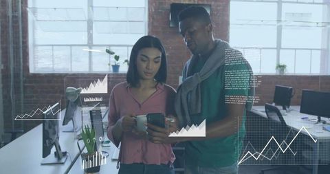 Tech colleagues analyzing data charts on smartphone in modern office