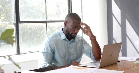 Professional Man Concentrating on Laptop in Office Environment