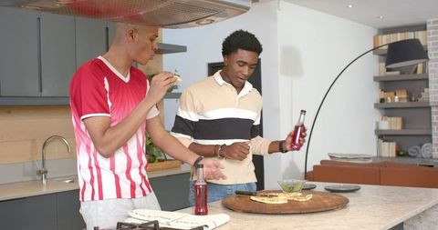 Casual Socializing in Modern Kitchen with Friends Enjoying Pizza