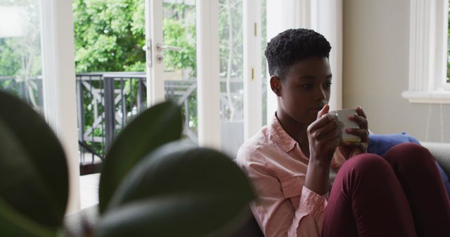 African American Woman Relaxing with Coffee at Home - Download Free Stock Images Pikwizard.com