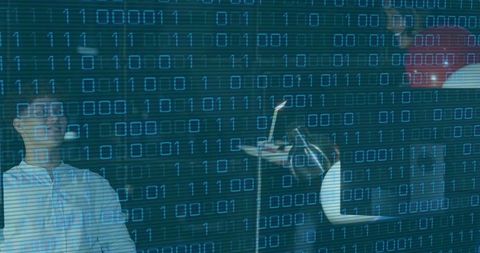 Woman and man recording in dark studio with binary code overlay for tech collaboration