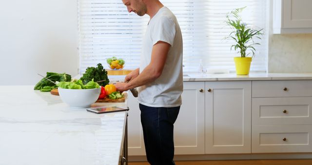 Man Preparing Fresh Vegetables in Bright Modern Kitchen - Download Free Stock Images Pikwizard.com