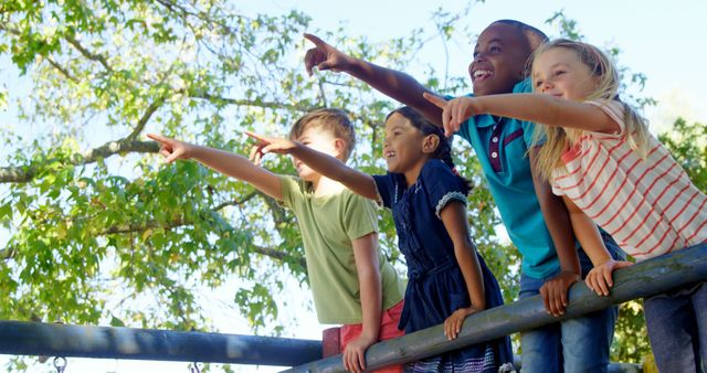 Diverse Group of Happy Children in Park Pointing at Something - Download Free Stock Images Pikwizard.com