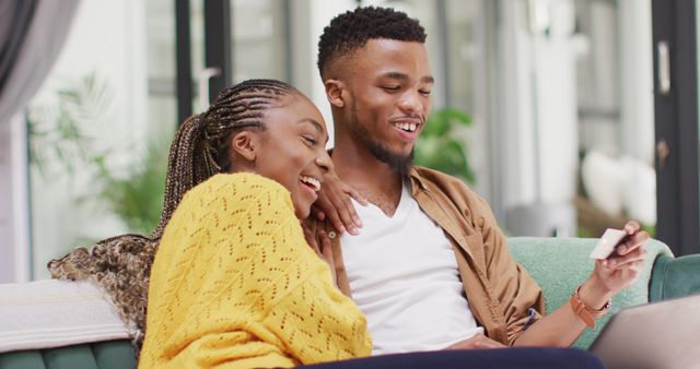 Happy african american couple relaxing outside house. Lifestyle, relationship, shopping and spending free time together concept.