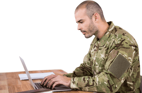 Transparent Military Soldier Using Laptop at Wooden Desk