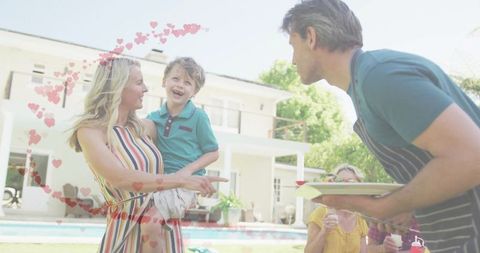 Joyful Family Celebration in Sunny Backyard with Smiling Child