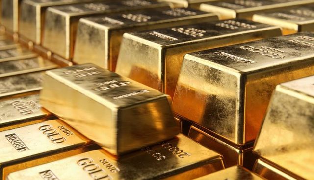 Glinting stacked gold bars reflecting warm light, bullion wealth and luxury vault concept