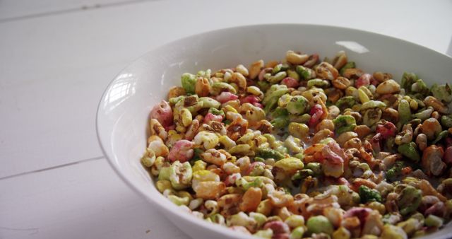 Bright, colorful cereal in a white bowl with milk. Perfect for advertising breakfast foods, kids' meals, and promoting a healthy and tasty start to the day.