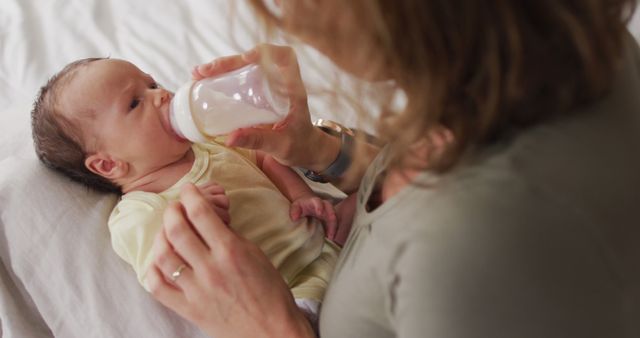 Mother Gently Feeding Newborn Baby with Bottle - Download Free Stock Images Pikwizard.com