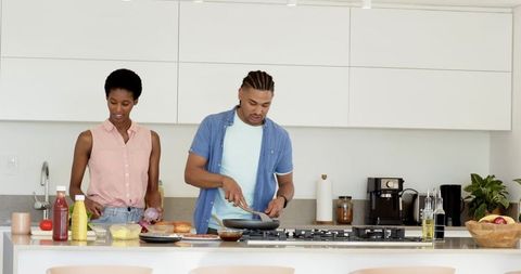 Diverse Couple Creating Delicious Burgers in Modern Kitchen