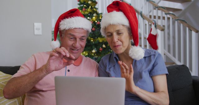 Happy caucasian senior couple having image call at christmas time. christmas, festivity and communication technology.