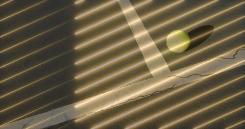 Sunlit stripes and shadow play on indoor table surface