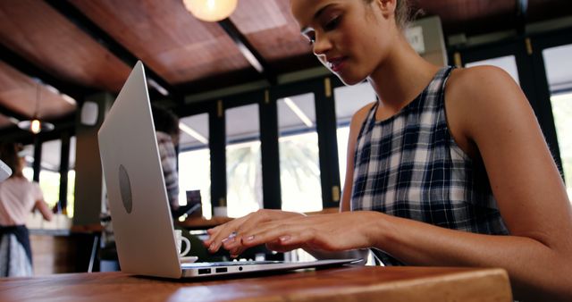 Woman Working on Laptop in Cozy Café Atmosphere - Download Free Stock Images Pikwizard.com