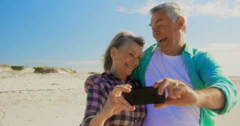 Cheerful Senior Couple Taking Selfie on Sunny Beach Day - Download Free Stock Images Pikwizard.com